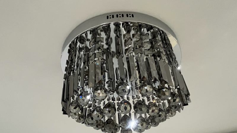 Crystal flush-mount ceiling light installed on a smooth ceiling
