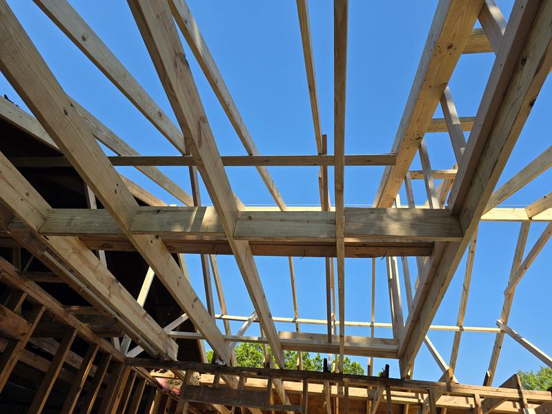 Exposed roof beams against blue sky
