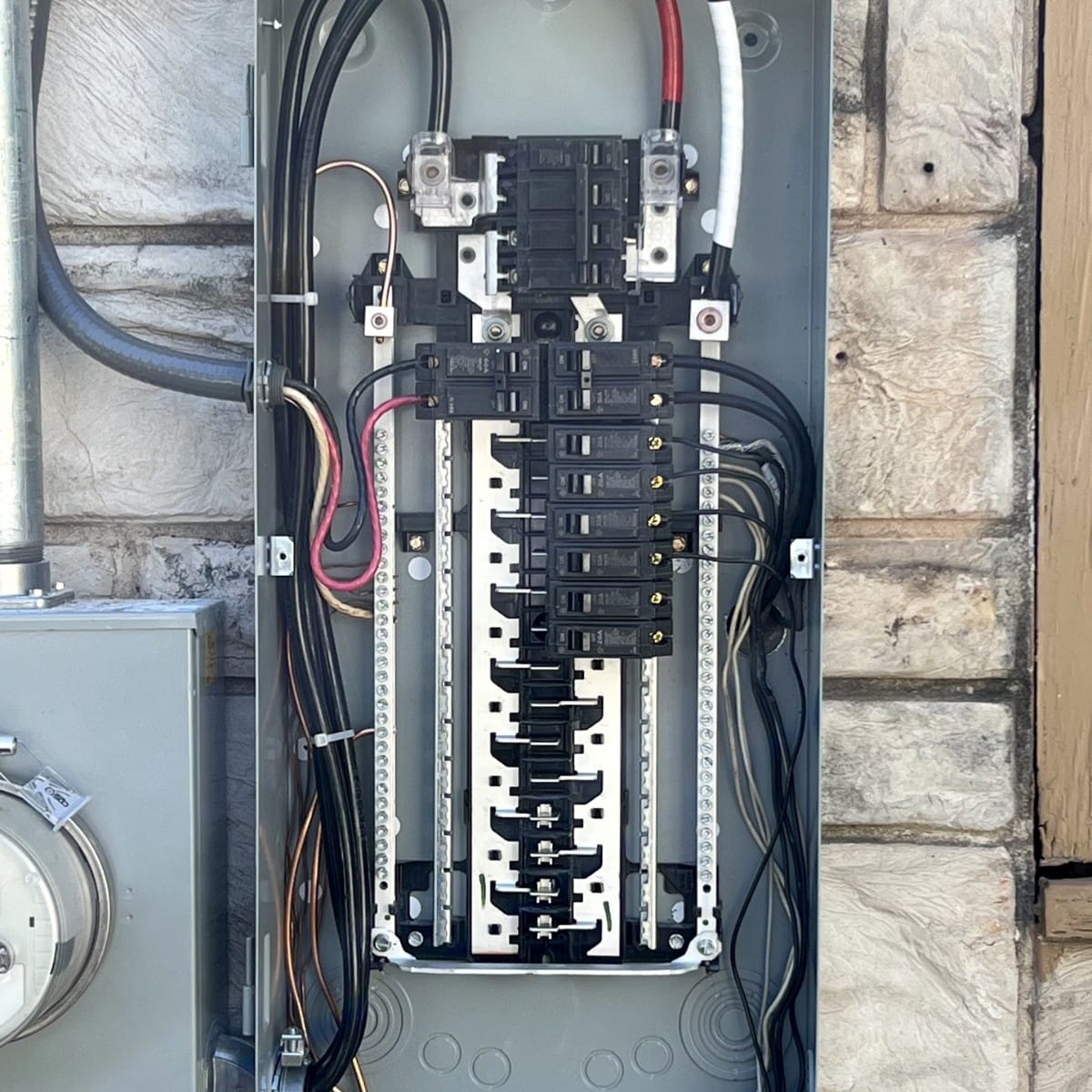 Exterior meter and breaker panel with new wiring for a home generator installation in San Antonio