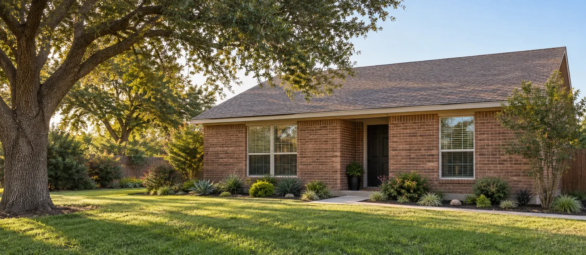 Illustration of a single-story red brick ranch with a side-gable roof and recessed front door.